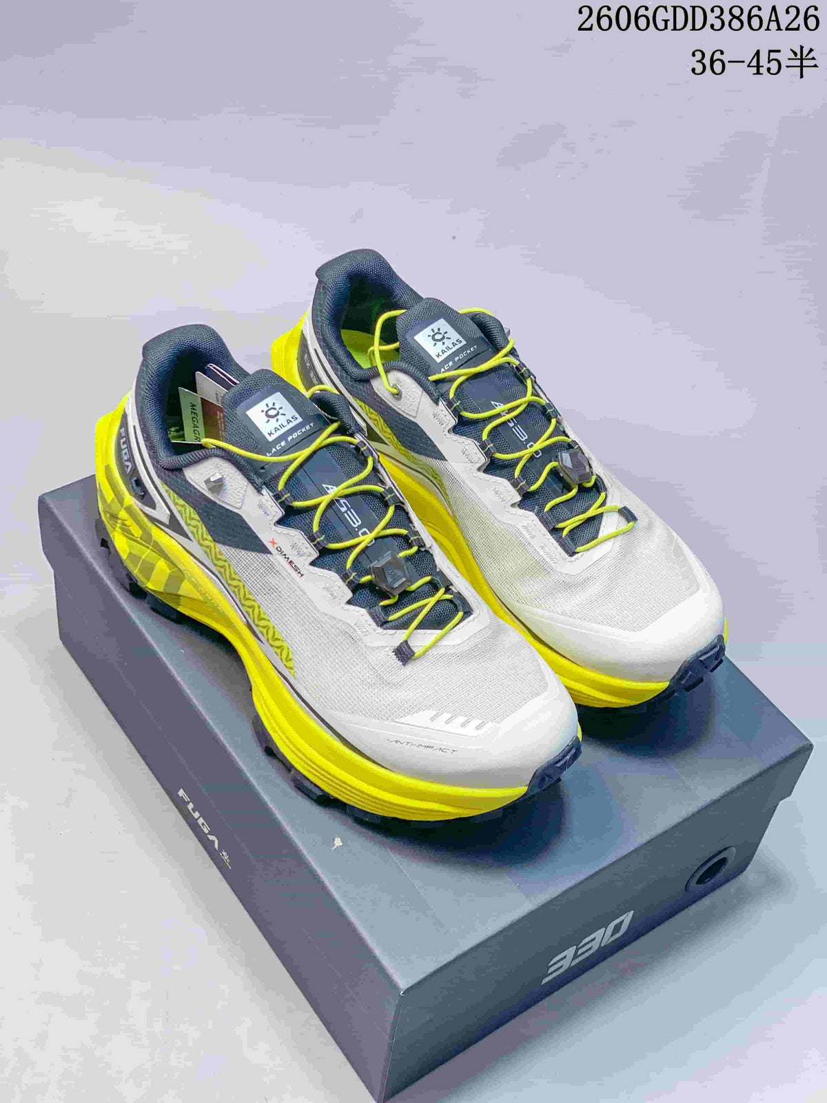 Pair of white, dark gray, and neon yellow Kailas FUGA EX330 trail running shoes on a 330 box