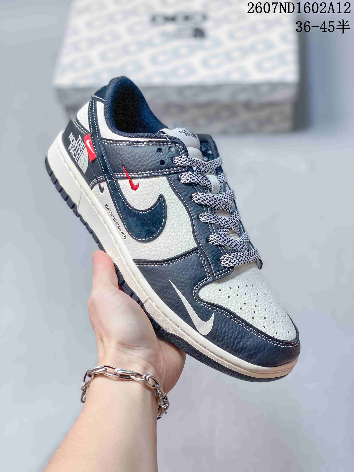 Angled side view of the sneaker showing Nike and The North Face branding, a dark navy and off-white upper, red accents, patterned laces and a dark outsole; product code and a 36–45 size range are overlaid above.