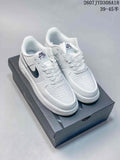 White and black Nike Air Force 1 '07 Low sneakers displayed on a shoebox, showing the perforated toe, laces and black Swoosh accents.