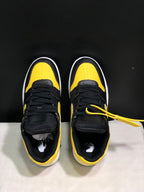 Top view of the pair showing black laces, yellow perforated toe panels, and padded tongues.