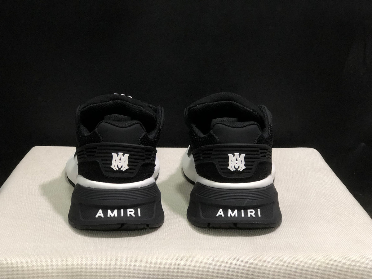 Rear view highlighting the padded heels, layered heel details, and AMIRI branding.
