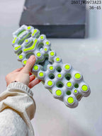 Close view of the sneaker outsole showing a segmented translucent sole with neon green traction details.