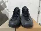 Front view of black Nike Air Max SNDR sneakers with laces and mesh-like toe panels.