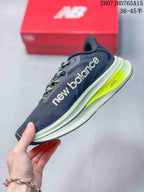 Side view of a New Balance RC Elite running shoe showing the large New Balance branding, dark navy upper, light midsole and neon yellow heel detail.
