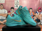 Pair of lake-blue Nike Kobe basketball shoes showing the side panels, laces, and gold-tone Swoosh.