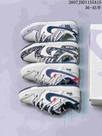 Four low-top sneakers arranged to show the pictured navy, white and gray design variations and their outsoles.