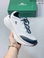 Angled side view of the white and navy Lacoste sneaker with dotted grid-pattern upper