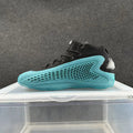 Black high-top sneaker with a bright blue honeycomb-patterned sole and silver-toned heel detail