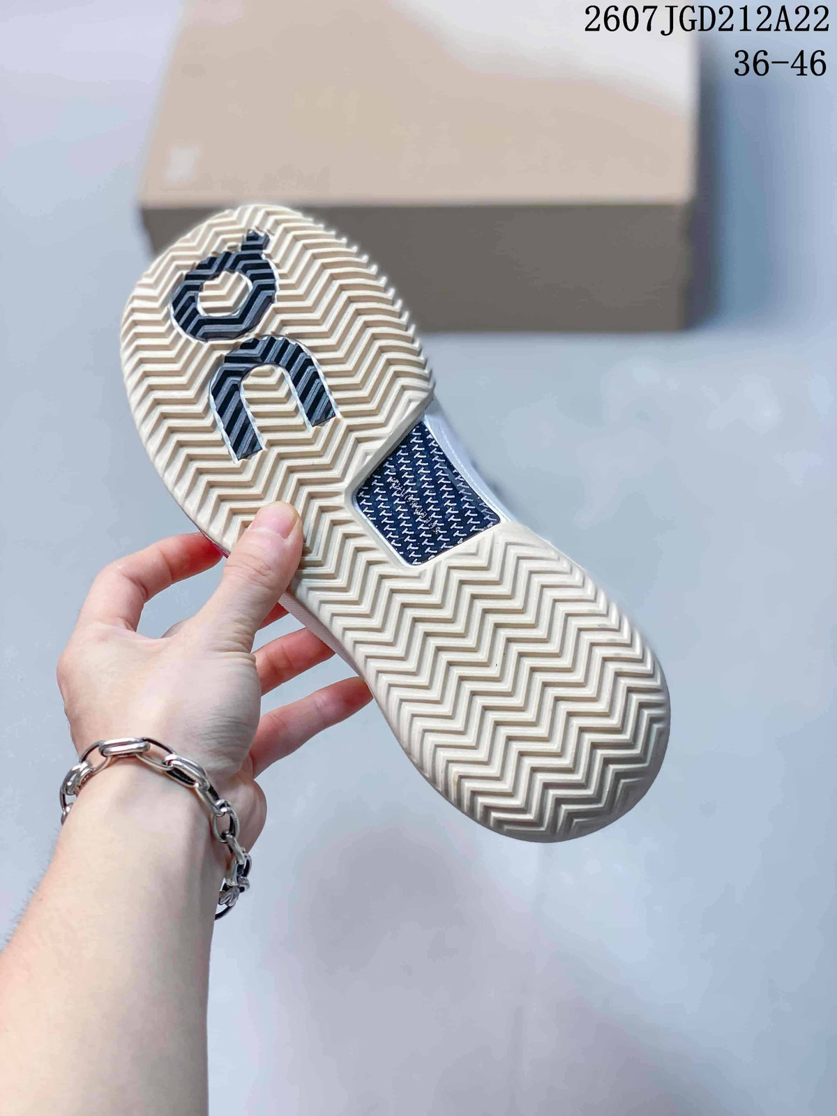 Underside view of the sneaker showing the cream-colored zigzag outsole pattern and On branding.
