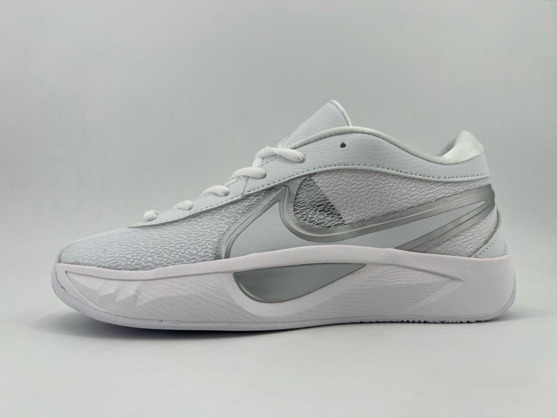 Side view of a white low-top Nike sneaker with a gray Swoosh, patterned upper, and thick white sole.