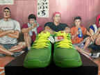 Front view of green basketball shoes with bright yellow-green laces.