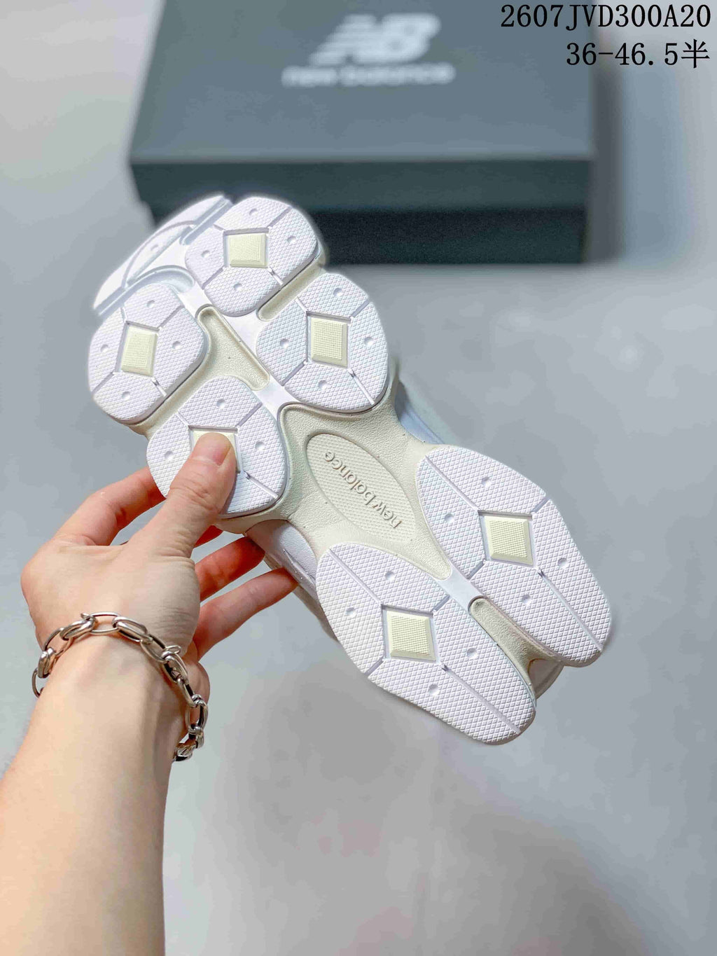 Underside view showing the segmented white outsole and tread pattern of the sneakers.