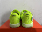 Rear view of bright green Nike basketball shoes with perforated heel panels and pale contrasting soles