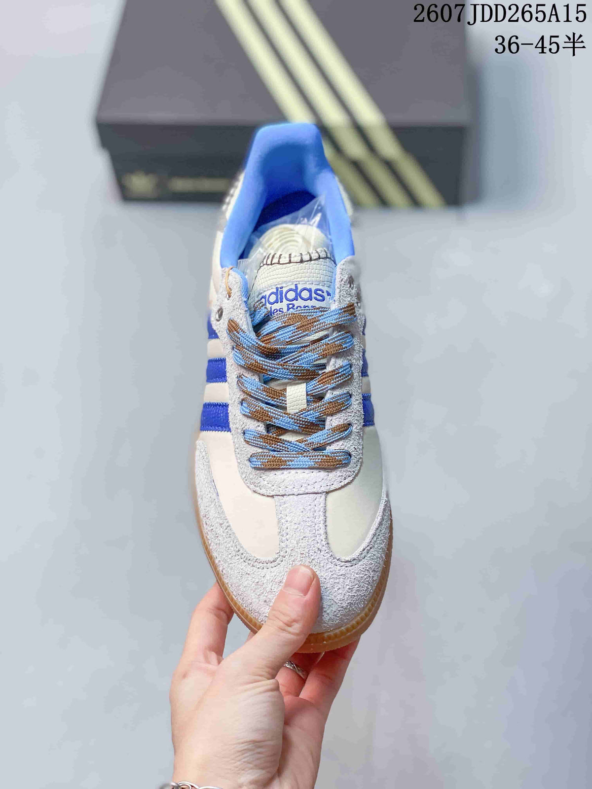 Top view showing the lace-up design, blue collar, textured overlays, and adidas tongue branding.