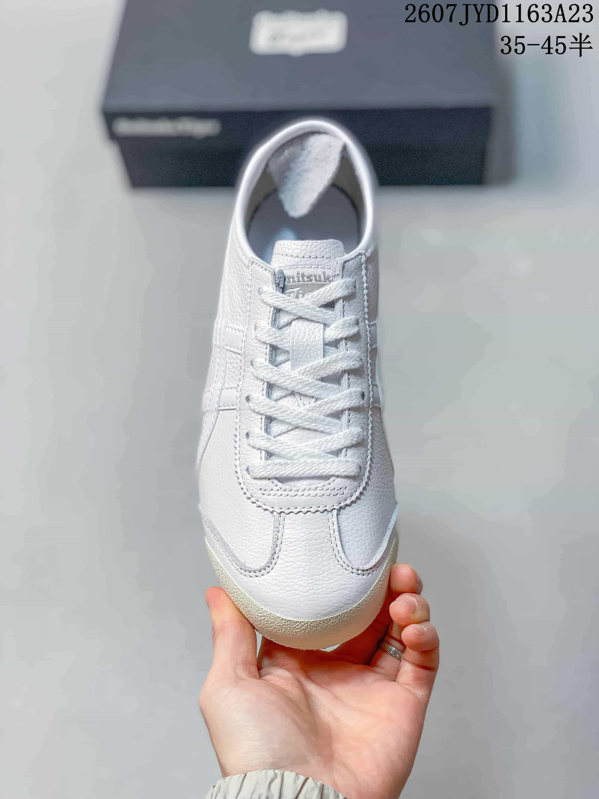 Top view showing the white lace-up sneaker with a rounded toe and pink detailing.