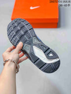 Close-up of the black patterned outsole showing textured tread sections.