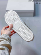 Close view of the white textured rubber outsole with patterned tread.