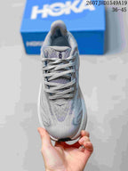 Top view of the gray and lavender sneaker showing the lace-up construction, padded tongue, and textured upper.