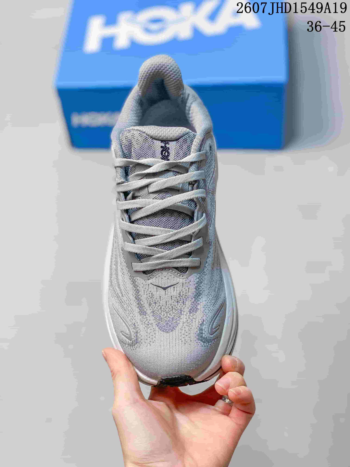 Top view of the gray and lavender sneaker showing the lace-up construction, padded tongue, and textured upper.