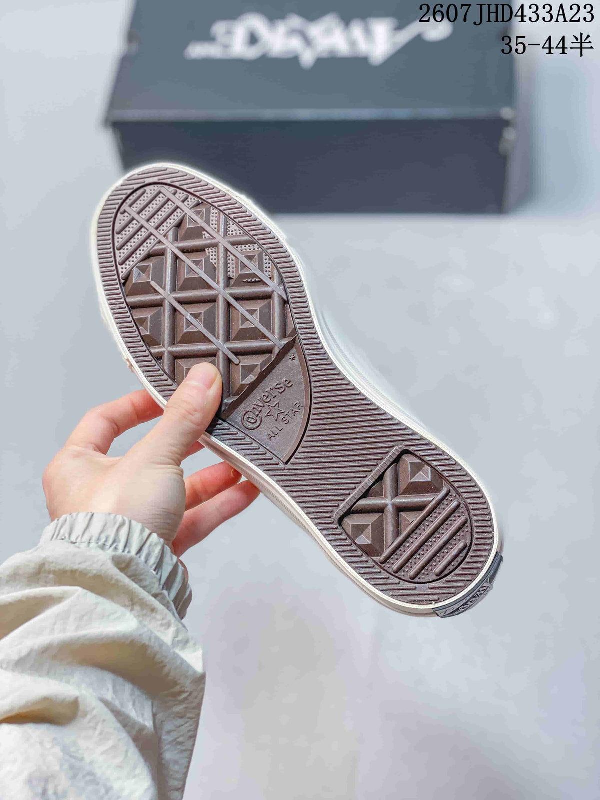 Close view of the patterned rubber outsole showing Converse All Star branding and geometric traction.
