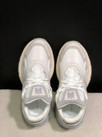 Top view showing the lace-up construction, layered panels and tongue branding.