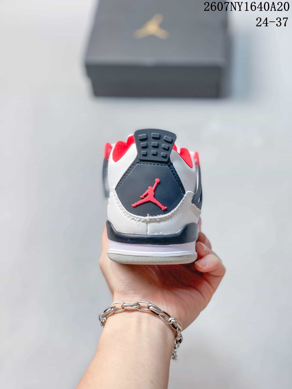 Rear view showing the black heel panel, red Jordan logo, and padded red collar.
