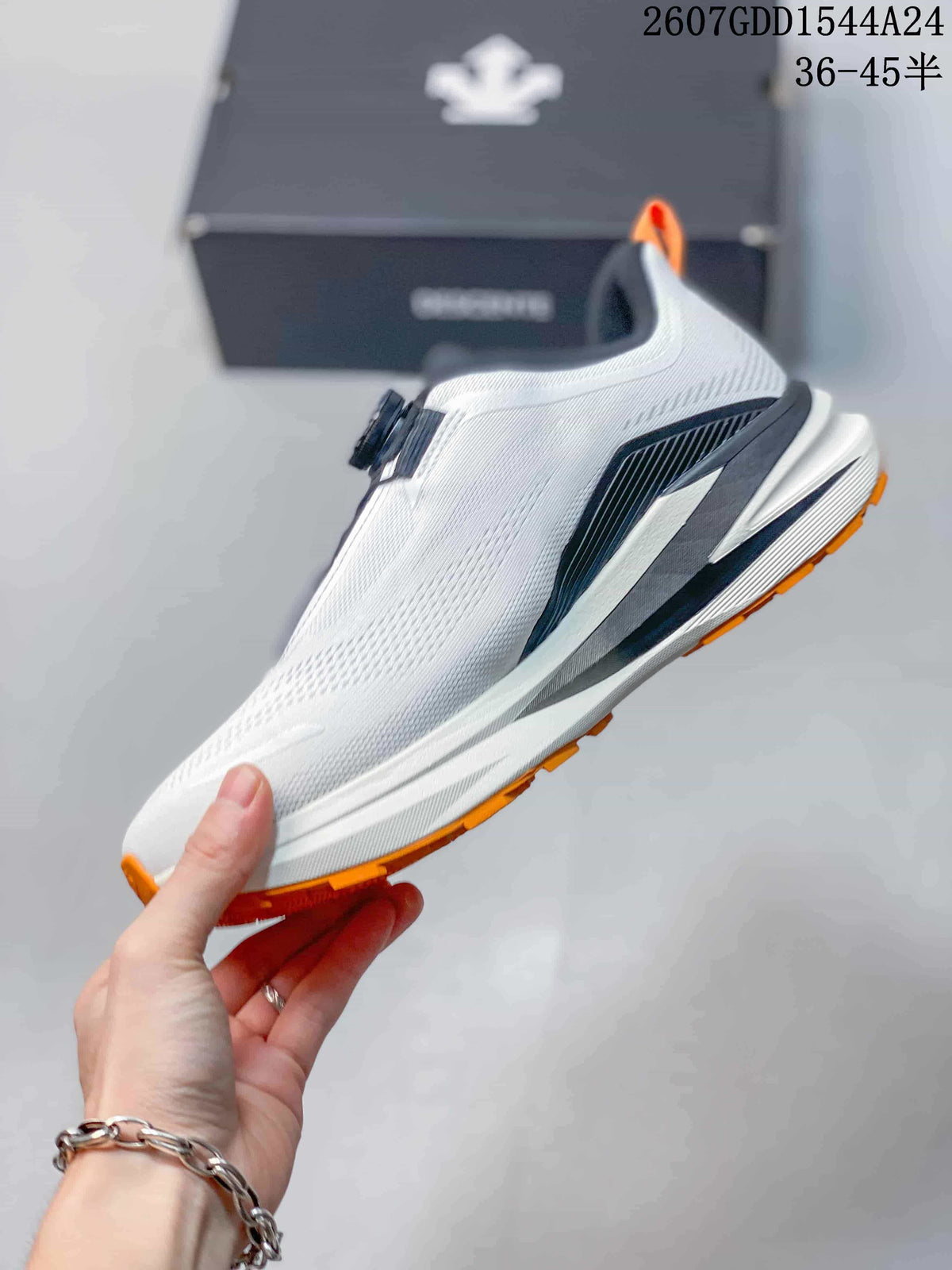 Side profile of the white sneaker showing the black midsole detail, orange outsole edge, and BOA-style closure.