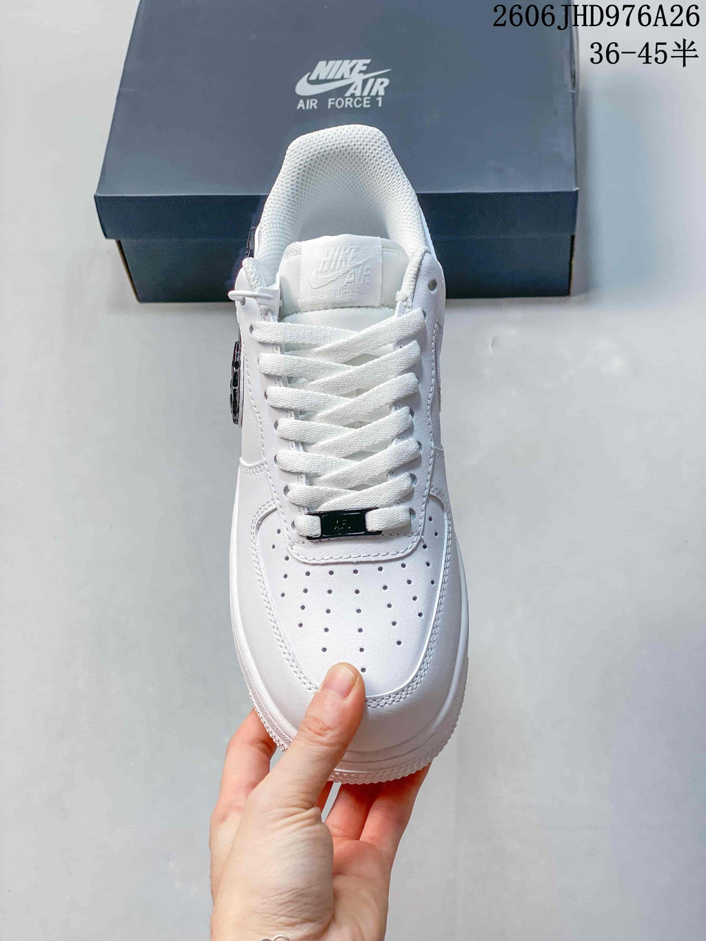 Front view of a white lace-up sneaker with a perforated toe box.