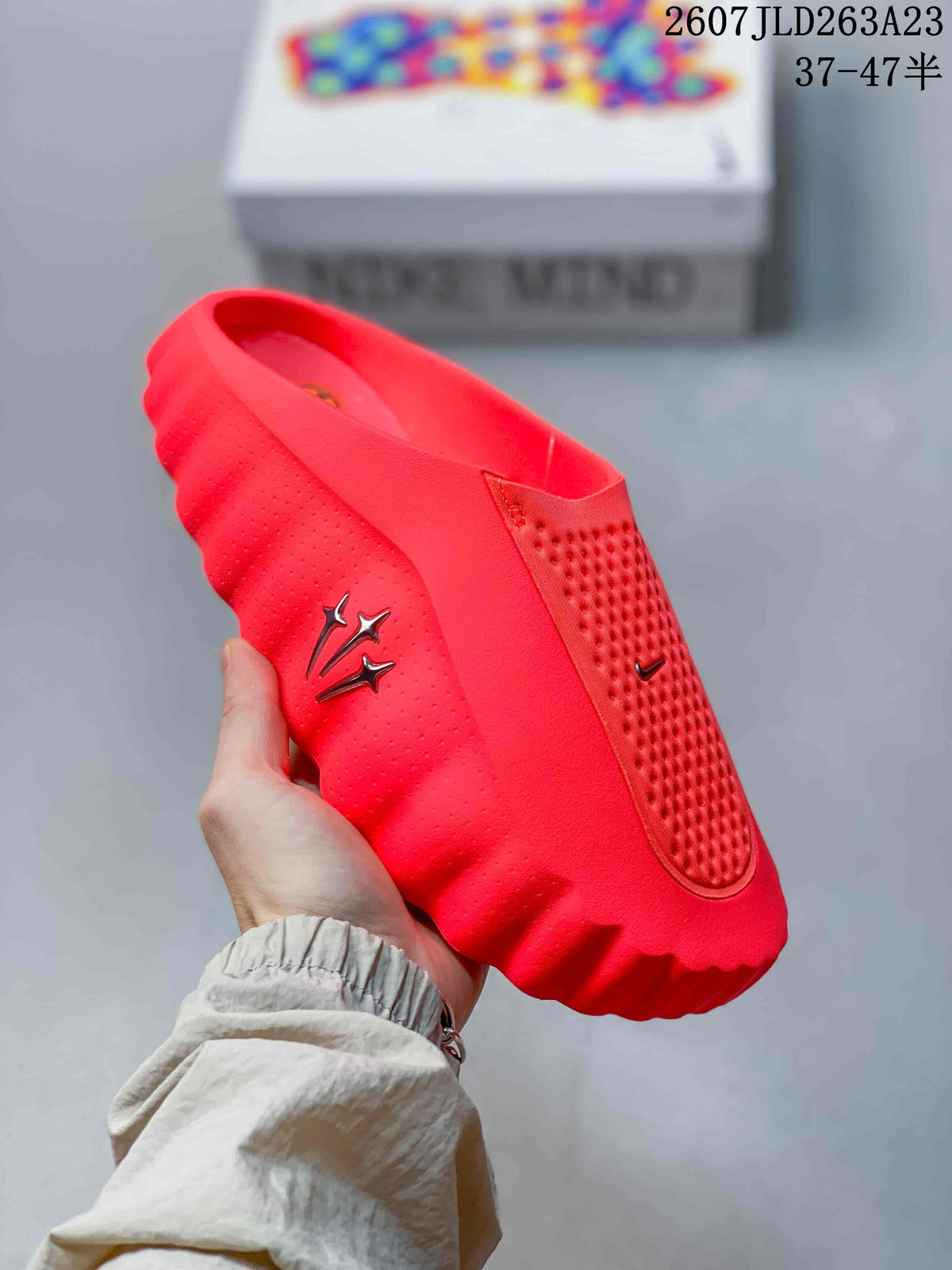 Close-up side view of a bright red Nike Mind 001 slide with perforated detailing, side branding and a thick sculpted outsole.