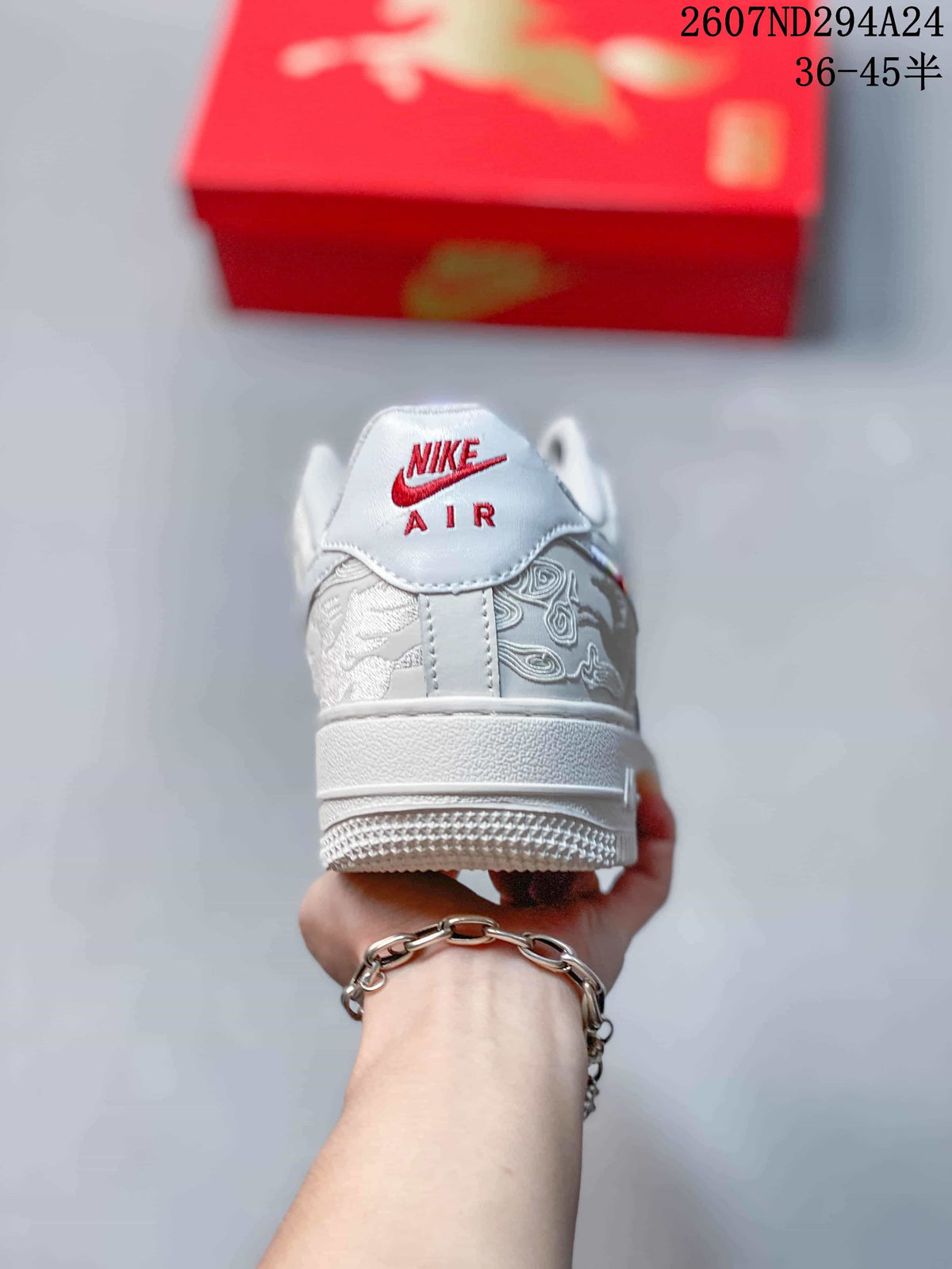 Rear view of the white sneaker showing the Nike Air tongue-style heel branding and layered outsole.