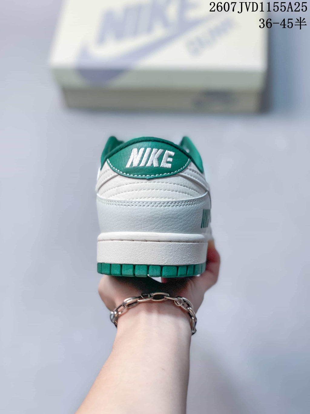 Rear view showing the white heel, green heel branding, and green outsole edge.