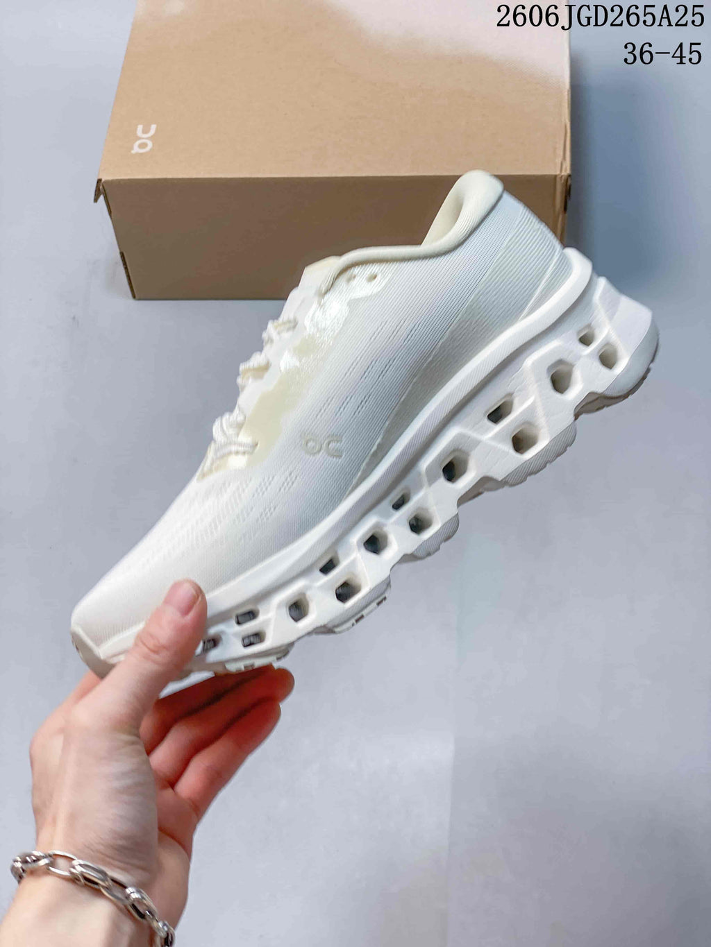 Side view of the white On Cloudmonster 3 shoe and sculpted sole