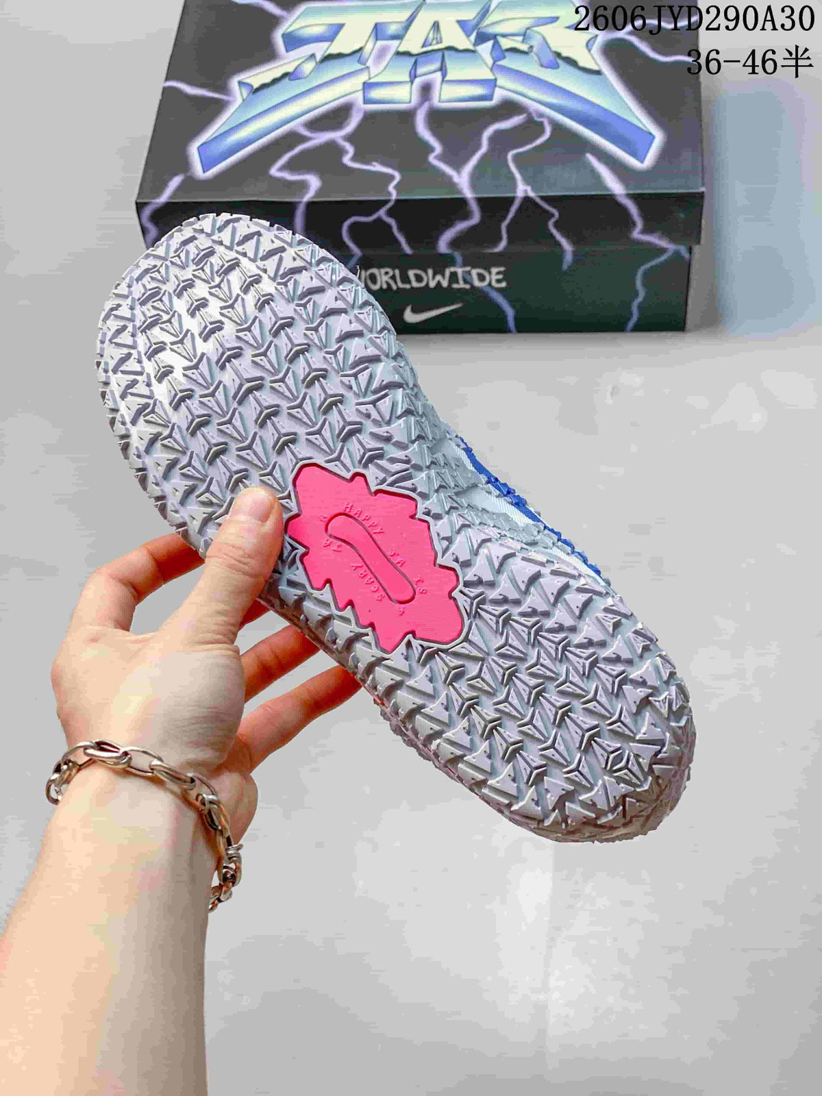 Close-up of the patterned outsole with a pink central detail.