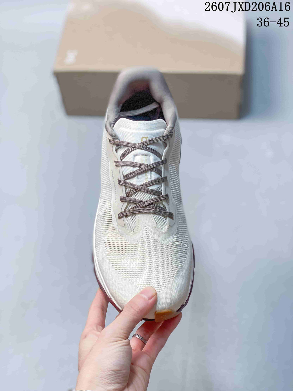 Top view showing the white toe box, gray laces and padded tongue.