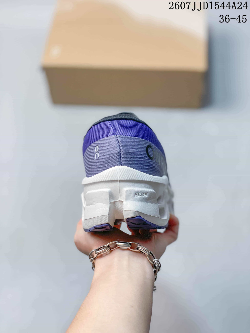 Rear view of the purple running shoe showing the padded collar, heel branding, and white midsole.