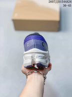 Rear view of the purple running shoe showing the padded collar, heel branding, and white midsole.