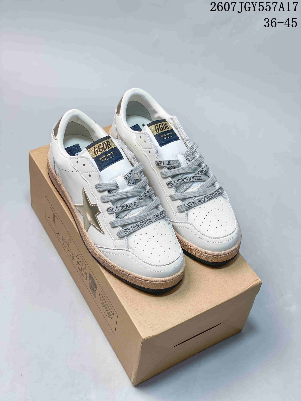 Pair of white and gold Golden Goose Ball Star sneakers displayed on a shoebox.