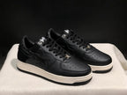 Three-quarter view of the black and white low-top sneakers with star side panels.