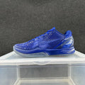 Side view of a blue Nike Kobe 6-style low-top basketball shoe with patterned upper and translucent-looking outsole