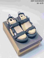 Pair of black and tan The North Face Explore Camp sandals displayed on a shoebox; style code JGD240A20 and size range 36–45 are visible.
