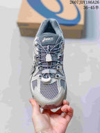 Top view of the ASICS sneaker showing the gray mesh-style toe area, layered overlays, cord-style lacing, and tongue branding.