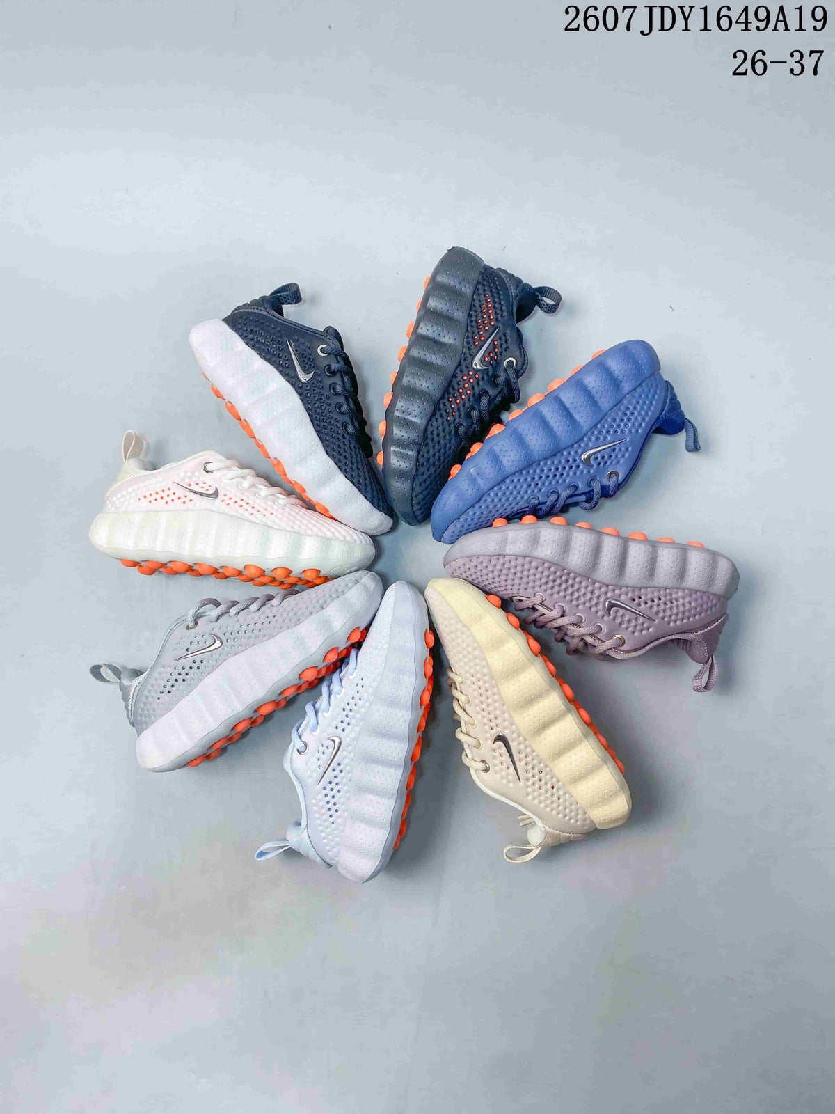 Group display of Nike Mind 002 kids sneakers in multiple colors and outsole combinations.