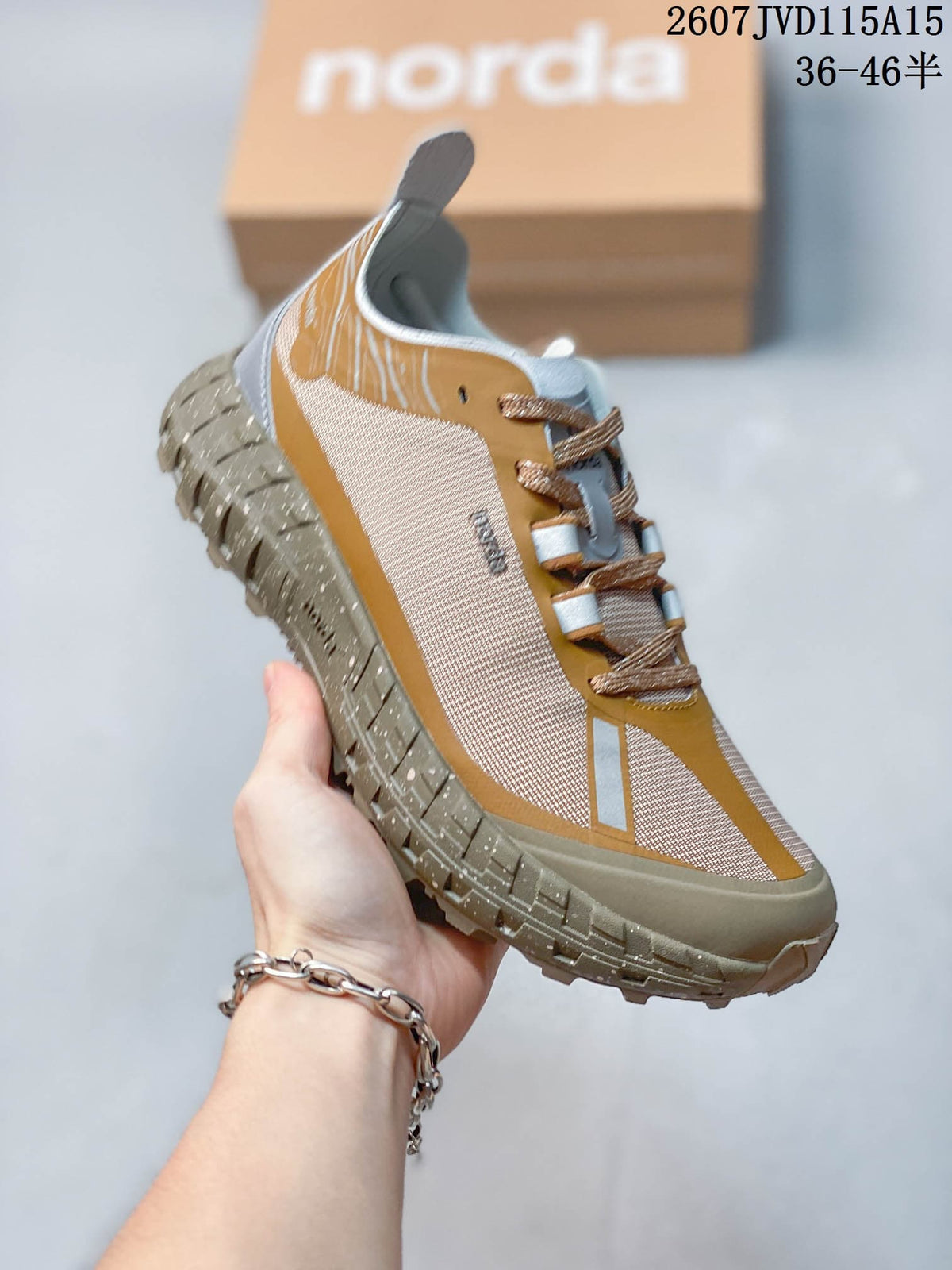 Angled side view of the NORDA sneaker highlighting the layered upper panels, laces, and rugged outsole.