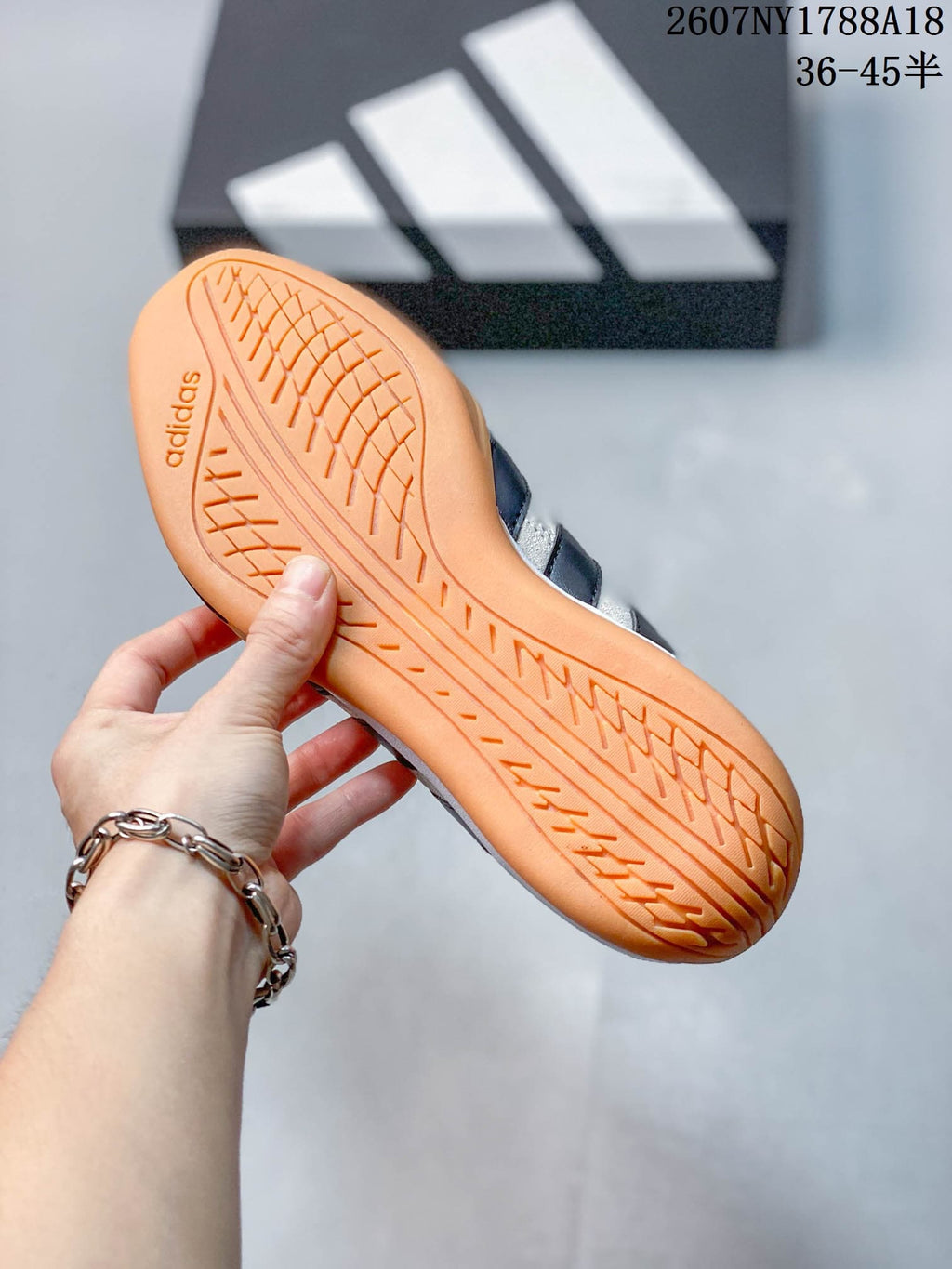 Close-up of the gum-colored outsole showing its textured tread pattern and adidas branding.