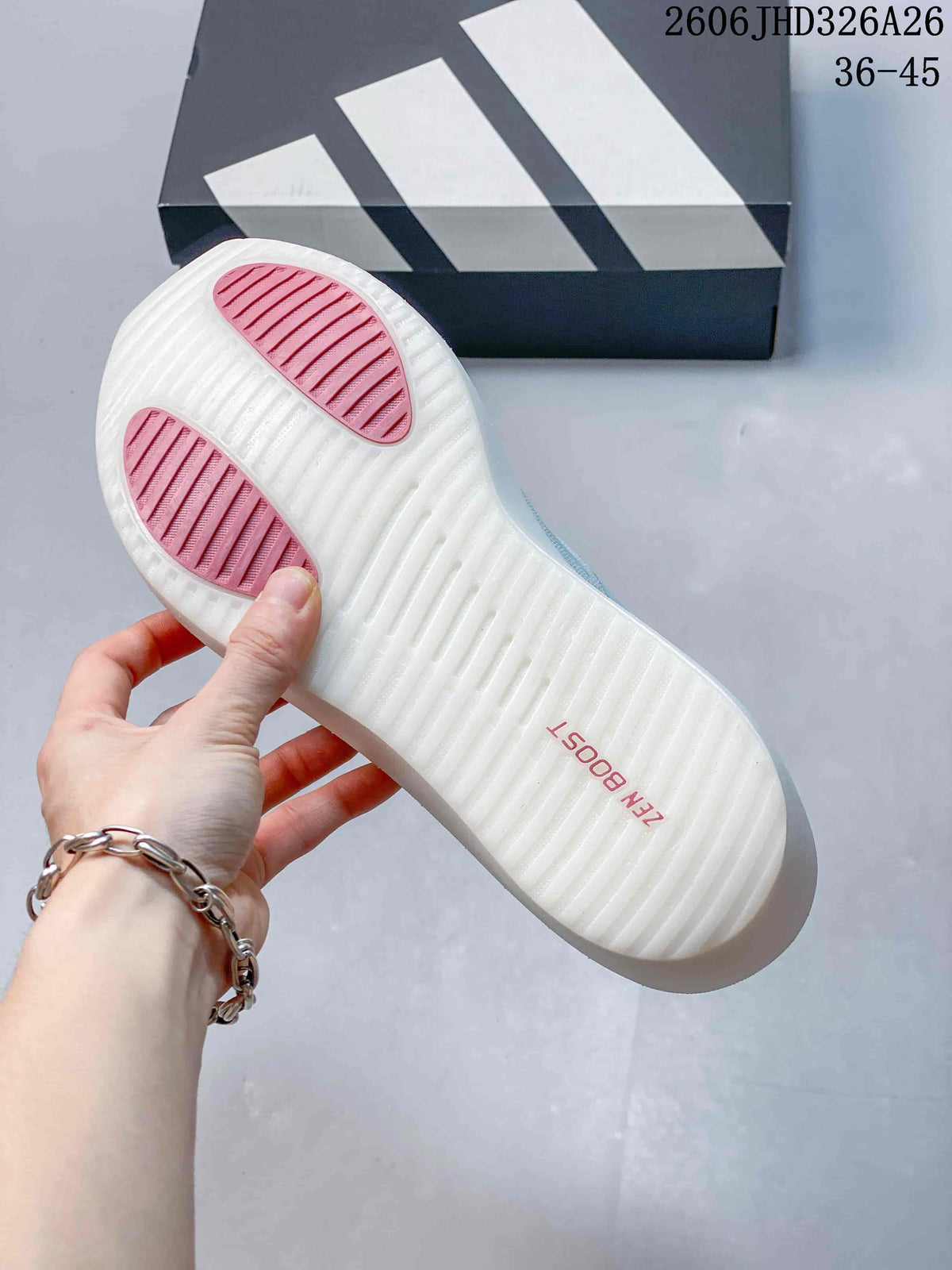 Underside of a white running shoe outsole with pink grip sections