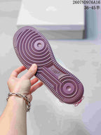 Close view of the dark pink circular-pattern rubber outsole.