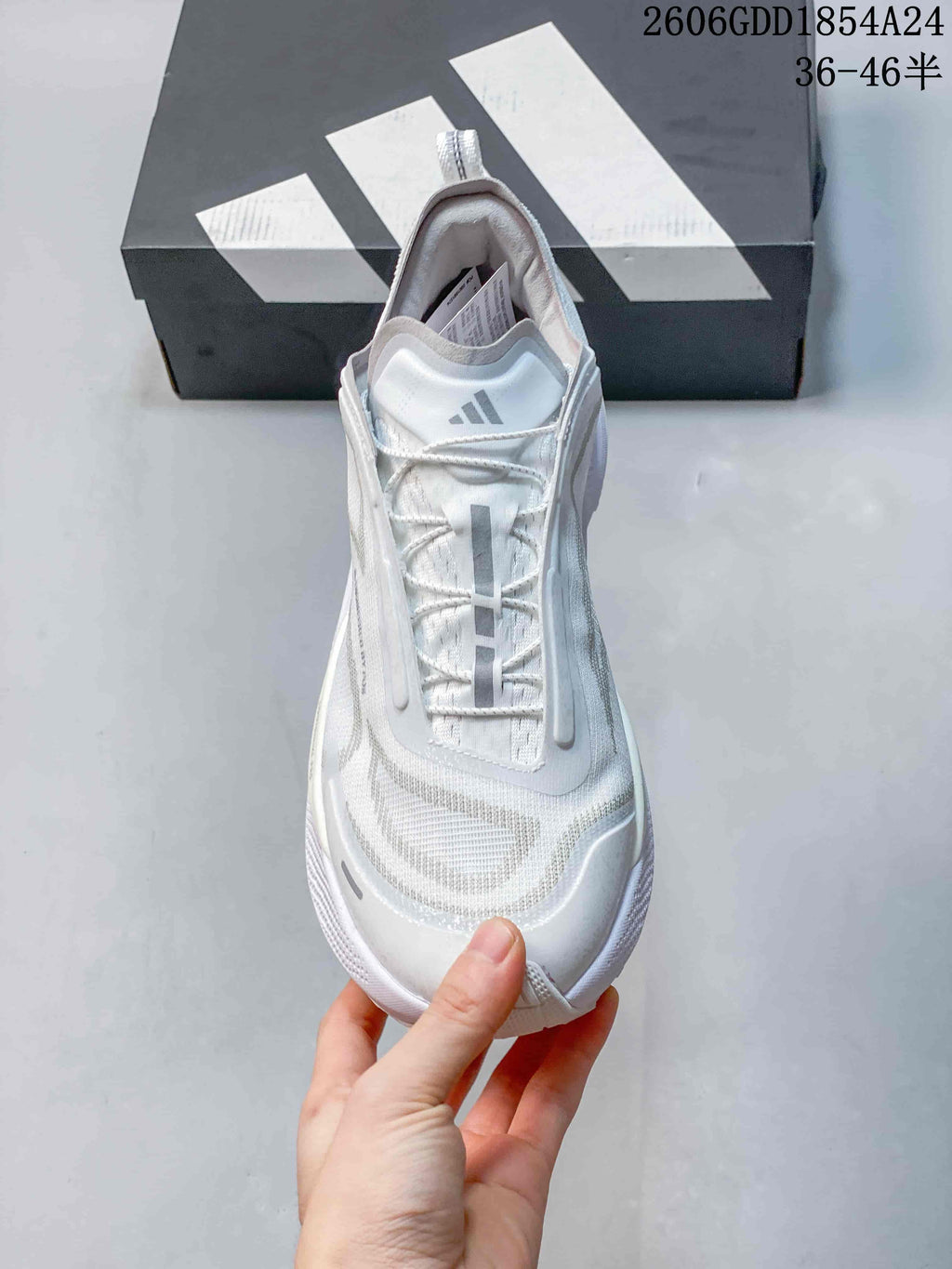 Top view of a white trail-running shoe with lace-up fastening