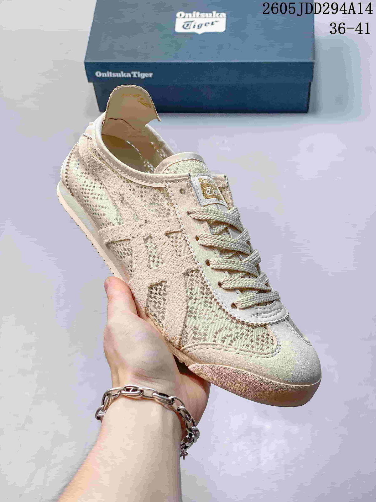 Close-up of a beige Onitsuka Tiger sneaker with patterned textile panels, lace-up closure, stitched side detailing, and a flat outsole.