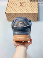 Rear view of the navy sneaker showing tan heel and outsole details