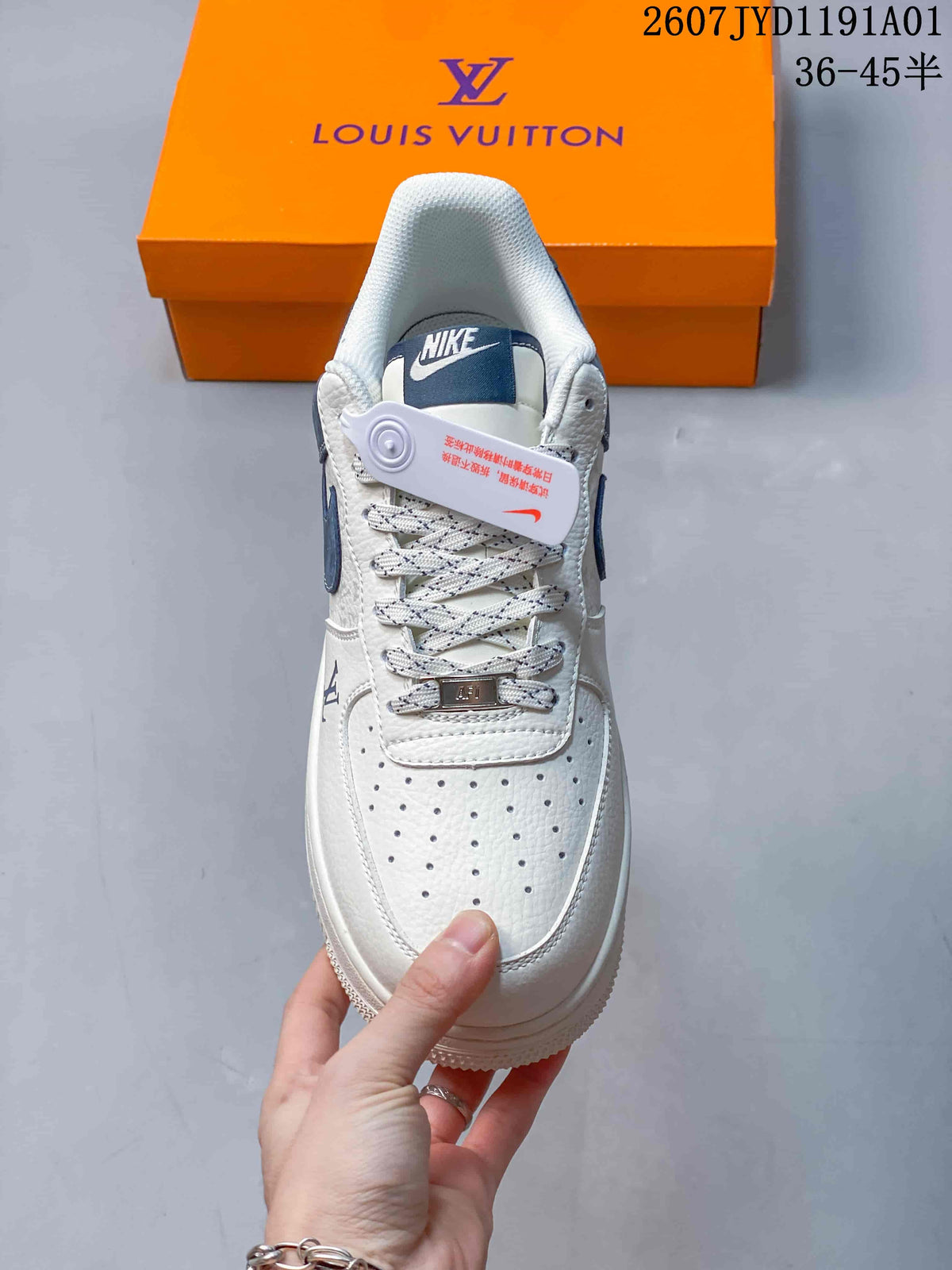 Front view of the sneaker showing a perforated toe, patterned laces, and navy tongue detail.